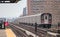 subway train on elevated track in the bronx with apartment buildings in the background (above ground metro line in nyc)