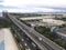 Sucat, Paranaque, Philippines - Aerial of SLEX and the Metro Manila Skyway. Several warehouses line the highway.