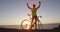 Success, achievement and accomplishment - man cycling cheering reaching goal