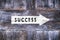 Success arrow sign on wooden background