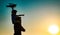 Success and child leader concept. Sunset silhouette of Father and son together. Boy child is sitting on daddy shoulder