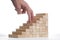 Success concept:stairs build with toy wooden blocks and two human finger climbing it on white background