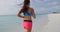 Success and determination concept video. Determined female runner jogging at beach during sunset. Sporty young woman