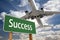 Success Green Road Sign and Airplane Above