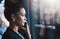 Success happens on her command. a young businesswoman talking on a cellphone in an office.