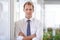 Success and nothing less. Portrait of a handsome businessman leaning against a glass wall.