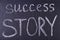 Success story phrase written with chalk on black board.