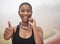 Success sure does taste sweet. Shot of a young female athlete giving the thumbs up while biting her medal.