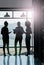 Success takes teamwork. Silhouette shot of female coworkers talking while standing in front of a window in an office.