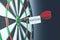 Success text on  dart on bullseye of a dart board