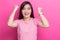 Success woman happy being a winner over pink background