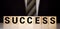 Success word written on wood block. Success text on wooden table for your desing
