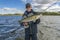 Success zander fishing. Happy fisherman with big walleye fish trophy at lake