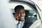 Successful African Businessman Speaking on Phone in Car