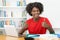 Successful afro american male student learning at desk