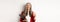 Successful asian businesswoman drinking coffee and winking cheerful at camera, standing with clipboard, wearing red