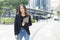 Successful asian businesswoman wear black suit holding tablet walking city street. woman freelancer lifestyle human urban.