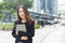 Successful asian businesswoman wear black suit holding tablet walking city street. woman freelancer lifestyle human urban.