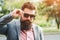 Successful bearded man in suit outdoors. Male fashion. Fashionable hairstyle and beard. Brutal confident man