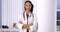 Successful black woman doctor standing in office