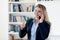 Successful blond businesswoman talking with client at phone