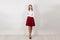 Successful and bold. Full length of happy young businesswoman with crossed arms, standing isolated against white wall. One single