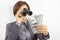 Successful business woman with binoculars and dollars in her hands. Search for financial investments