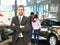 Successful businessman in a car dealership - sale of vehicles to