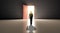 Successful businessman walking in front of bright door in concrete interior with shadow on floor. Future, success and dream