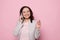 Successful businesswoman, entrepreneur talking on mobile phone, smiling looking at camera, isolated on pink background