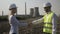 Successful businesswoman and handsome engineer shaking hands agreeing project deal in oilfield and energetic industry -