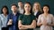 Successful businesswoman posing with multiracial colleagues in office