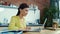 Successful businesswoman using laptop in kitchen. Woman receiving good message