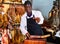 Successful butcher shop owner recommending to taste delicious iberian ham