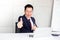 Successful confident businessman ,showing thumbs up or like sitting at office desk,success, good idea, great job business concept