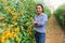 Successful confident Hispanic female grower in greenhouse