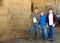 Successful elderly dairy farm owner with adult son and teen grandson standing in hayloft