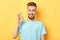 Successful excited man with funny moustache is standing  in the studio