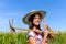 Successful female farmer with grubbing hoe in a corn field