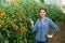 Successful female grower in greenhouse near yellow grape tomatoes