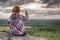 Successful female hiker takes photo at edge