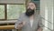 Successful funny business man with beard celebrating success by dancing at the office -