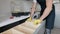 Successful furniture assembly worker adjusting shelf. Finishes his job for cabinet at the kitchen. Professional handyman