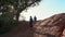 Successful, happy middle-aged woman and a young girl doing a sports walk on a rock, cliff. Mother and daughter.