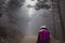 successful hiker woman walking on the fog. autumn or winter season