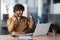 Successful hispanic businessman programmer celebrating victory and triumph, man inside office sitting at table and