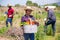 Successful latino farmer with basket of vegetables at the plantation