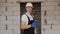 A successful male construction worker in a white hard hat gives a thumbs up.