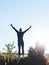 Successful man raising arms after cross track running