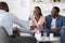 Successful Marital Therapy. Happy Black Spouses Handshaking With Family Counselor After Reconciliation